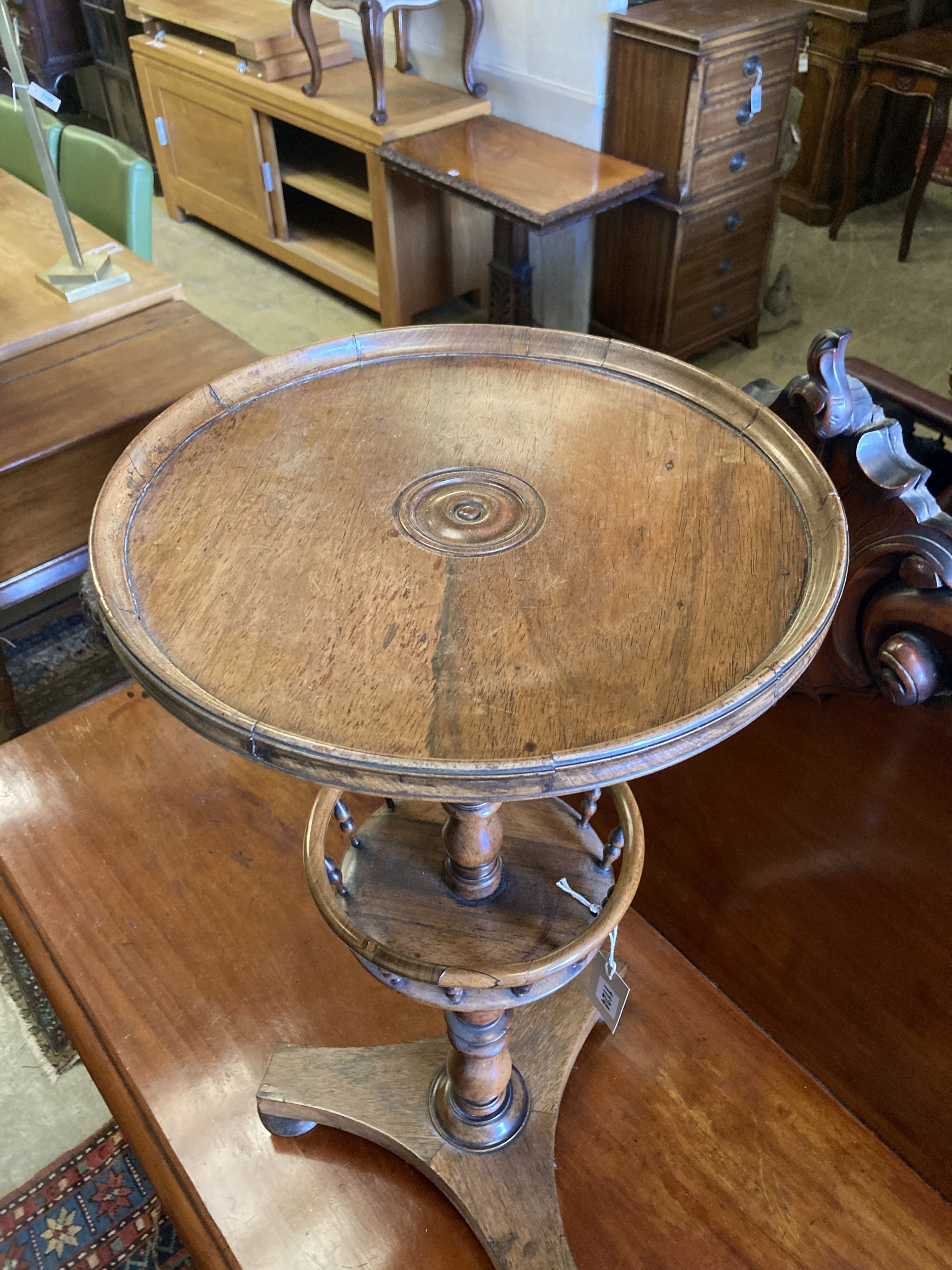 An early Victorian circular rosewood candlestand with galleried shelf on platform base, diameter 35cm, height 72cm